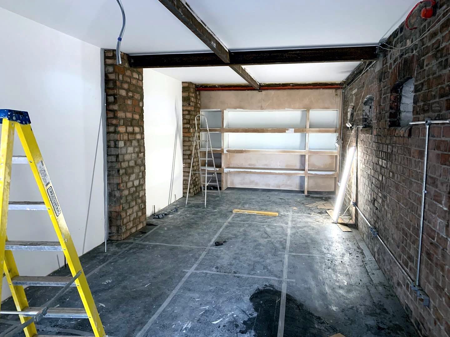 Unit mid-renovation, stripped back to brick with new steel beams
